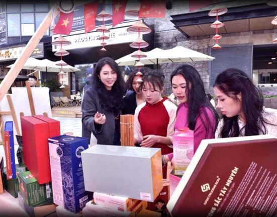 Visitors tasting Pakistani snacks at a busy Pakistani food stall during an international New Year fair in Chongqing, China.
